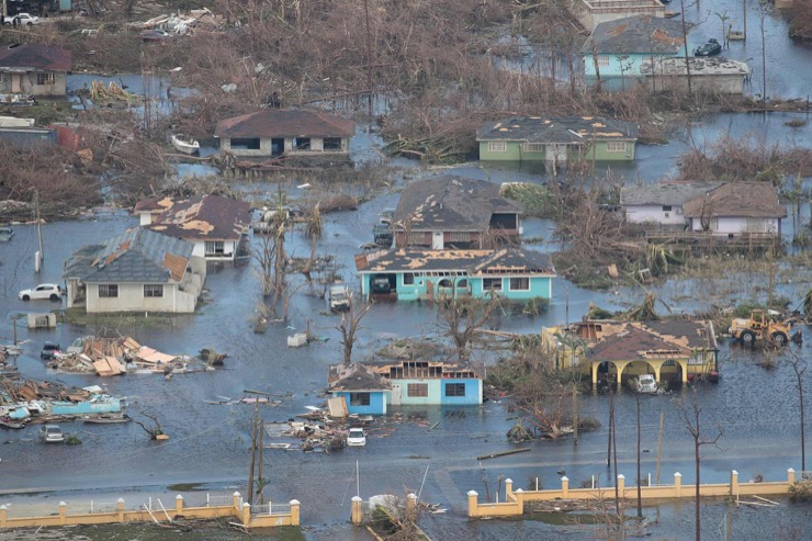 The Bahamas sustained monumental damage with neighborhood on the northern side submerged by 7m storm surges. Source: Scott Olson/Getty Images Via The Guardian